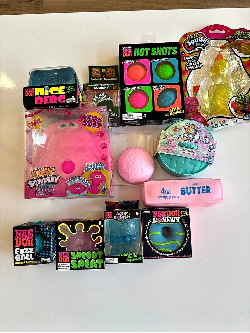 NeeDoh assortment including Easy Squeezy Kitty Sensory Toy Assortment in Pink &